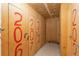 Hallway with plywood storage units, each clearly marked with unit numbers for easy identification at 5770 E Warren Ave # 206, Denver, CO 80222