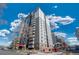 Condominium building exterior showcasing modern design, balconies, and beautiful landscaping at 2 Adams St # 905, Denver, CO 80206