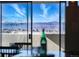 Stunning mountain views seen through a window from a dining area in this beautiful home at 2 Adams St # 905, Denver, CO 80206