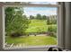 View of the lush green back yard through a double hung window at 2061 Chesapeake Pl, Highlands Ranch, CO 80126