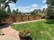 Beautiful backyard with a well-manicured lawn, privacy fence, and colorful flower arrangements at 2061 Chesapeake Pl, Highlands Ranch, CO 80126