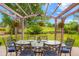 Outdoor dining area features a pergola with hanging lights, perfect for entertaining at 2061 Chesapeake Pl, Highlands Ranch, CO 80126