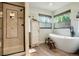 Bright bathroom with soaking tub, walk in shower, and wood look floors at 2061 Chesapeake Pl, Highlands Ranch, CO 80126