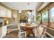 Dining area with chandelier, hardwood floors, and a connection to the kitchen and living area at 2061 Chesapeake Pl, Highlands Ranch, CO 80126