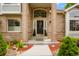 Inviting front entrance with a decorative door, brick accents, and manicured landscaping at 2061 Chesapeake Pl, Highlands Ranch, CO 80126