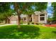 Beautiful home with mature trees, a well-manicured lawn, and a charming brick exterior at 2061 Chesapeake Pl, Highlands Ranch, CO 80126