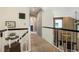 Upstairs hallway featuring neutral colors and overlooking the living room at 2061 Chesapeake Pl, Highlands Ranch, CO 80126