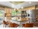 Kitchen island featuring stainless steel appliances, pendant lighting, and hardwood floors at 2061 Chesapeake Pl, Highlands Ranch, CO 80126