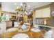 Kitchen with island, stainless appliances, and seating, flowing into the dining area and living room at 2061 Chesapeake Pl, Highlands Ranch, CO 80126