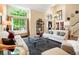 Bright living room featuring large windows, high ceilings, and stylish furnishings at 2061 Chesapeake Pl, Highlands Ranch, CO 80126