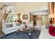 Spacious living room with soaring ceilings, stylish furniture, and plenty of natural light at 2061 Chesapeake Pl, Highlands Ranch, CO 80126