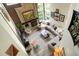 Bright living room boasting high ceilings, a brick fireplace, and ample natural light at 2061 Chesapeake Pl, Highlands Ranch, CO 80126
