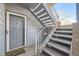 Apartment entryway with stairs to the upper level and a gray entry door at 8035 W Eastman Pl # 104, Lakewood, CO 80227