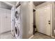 Laundry room with stacked washer/dryer and storage at 8035 W Eastman Pl # 104, Lakewood, CO 80227