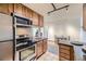 Eat-in kitchen, stainless steel appliances, and granite countertops at 1050 N Corona St # 215, Denver, CO 80218