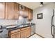 Updated kitchen featuring stainless steel dishwasher and granite countertops at 1050 N Corona St # 215, Denver, CO 80218