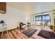 Living room with hardwood floors, access to balcony, and comfortable seating at 1050 N Corona St # 215, Denver, CO 80218