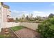 A cozy, fenced backyard with a well-kept lawn, brick patio, and lush greenery, creating a private outdoor retreat at 9685 W Chatfield Ave # A, Littleton, CO 80128