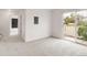 Spacious room with sliding glass door leading to a private patio and plush neutral carpet at 9685 W Chatfield Ave # A, Littleton, CO 80128