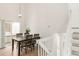 Bright dining area with modern lighting, wooden table, and access to outdoor space, perfect for entertaining at 9685 W Chatfield Ave # A, Littleton, CO 80128