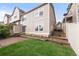 Exterior view of home's backyard with private patio, lawn, and siding, perfect for relaxing or entertaining guests at 9685 W Chatfield Ave # A, Littleton, CO 80128