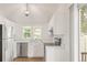 Modern kitchen with stainless steel appliances, white cabinets, and ample counter space, perfect for cooking at 9685 W Chatfield Ave # A, Littleton, CO 80128