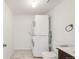 Bright laundry room featuring a stacked washer and dryer for space-saving convenience at 9685 W Chatfield Ave # A, Littleton, CO 80128