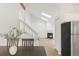 Open living space with wood floors, skylights, a fireplace, and modern staircase blending seamlessly at 9685 W Chatfield Ave # A, Littleton, CO 80128
