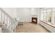 Bright living room featuring a cozy fireplace, modern flooring, and natural light from a large window at 9685 W Chatfield Ave # A, Littleton, CO 80128