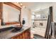 Stylish bathroom features a vessel sink, wood vanity, and a separate tub and shower at 2146 S Scranton Way, Aurora, CO 80014