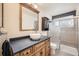 Chic bathroom with vessel sink, wood cabinet, and glass-enclosed walk-in shower at 2146 S Scranton Way, Aurora, CO 80014