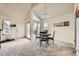 Cozy dining area with elegant lighting, large windows, and a view of the outdoor deck at 2146 S Scranton Way, Aurora, CO 80014