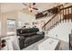 Open-concept living room featuring soaring ceilings, staircase, and comfortable seating area at 2146 S Scranton Way, Aurora, CO 80014