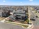 Aerial view of modern homes with lush landscaping, solar panels, and beautiful mountain views at 1730 W 67Th Ave, Denver, CO 80221