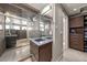 Bathroom featuring a glass shower, modern vanity, and custom closet with built-in shelving for ample storage at 1730 W 67Th Ave, Denver, CO 80221