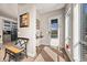 Bright entryway featuring hardwood floors, natural light, and a view of the kitchen area at 1730 W 67Th Ave, Denver, CO 80221
