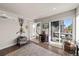 Versatile room, with a sliding door leading to an outside patio, and a hall to the staircase at 1730 W 67Th Ave, Denver, CO 80221