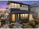 Charming two-story home featuring a modern design, brick accents, and a welcoming yellow front door at 1730 W 67Th Ave, Denver, CO 80221