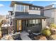 Charming two-story home featuring a modern design, brick accents, and a welcoming yellow front door at 1730 W 67Th Ave, Denver, CO 80221