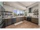 Modern kitchen features stainless steel appliances, sleek cabinets, and abundant natural light from large windows at 1730 W 67Th Ave, Denver, CO 80221