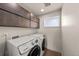 Convenient laundry room with modern appliances, sleek cabinets, and natural light at 1730 W 67Th Ave, Denver, CO 80221