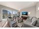 Comfortable living area with large windows, modern decor, and seamless access to the outdoor space at 1730 W 67Th Ave, Denver, CO 80221