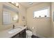 Stylish powder room with a modern vanity, sleek fixtures, and a well-lit mirror at 1730 W 67Th Ave, Denver, CO 80221