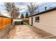 Enclosed backyard with concrete patio and access door to the home at 9280 Russell Way, Thornton, CO 80229