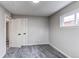 Bright bedroom features a window offering plenty of natural light, neutral gray carpet and closet at 9280 Russell Way, Thornton, CO 80229