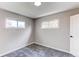 Bright bedroom features two windows offering plenty of natural light and neutral gray carpet at 9280 Russell Way, Thornton, CO 80229