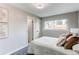 Serene bedroom with a plush bed, soft lighting, and ample natural light at 9280 Russell Way, Thornton, CO 80229