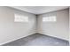 Bright bedroom features two windows offering plenty of natural light and neutral gray carpet at 9280 Russell Way, Thornton, CO 80229