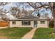 Charming home with a well-manicured lawn, solar panels and a light blue front door at 9280 Russell Way, Thornton, CO 80229