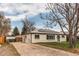 Charming home with solar panels, black shutters and a light blue front door at 9280 Russell Way, Thornton, CO 80229